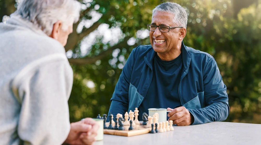 Two men smiling and playing chess