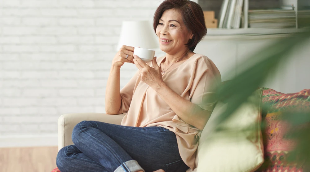 A woman sitting and drinking tea