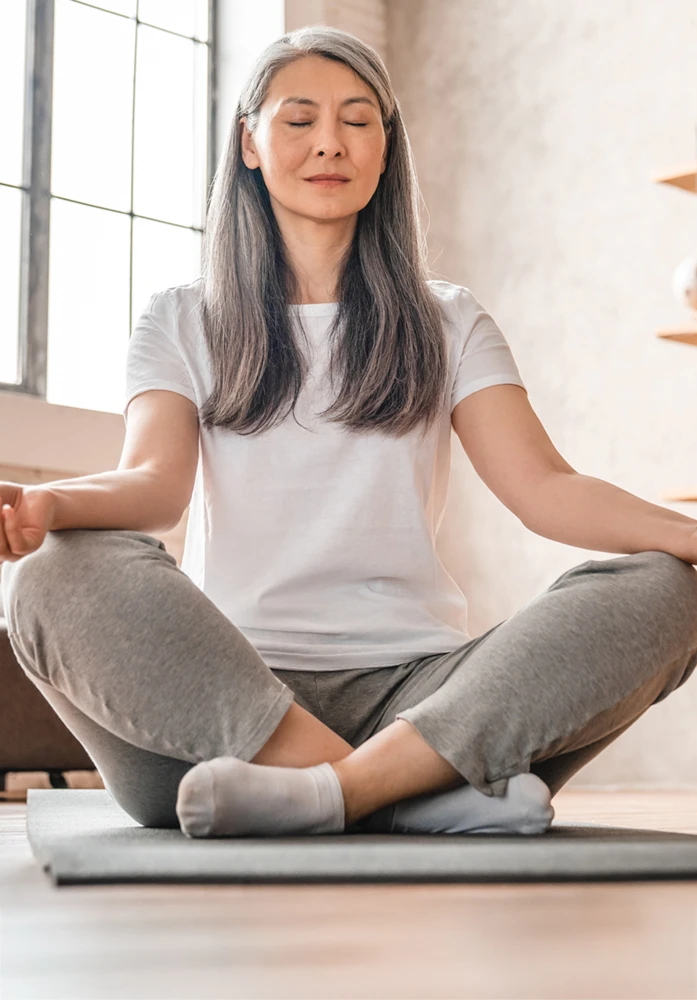 Mature woman meditating