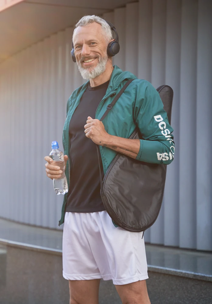 Mature man with tennis racket