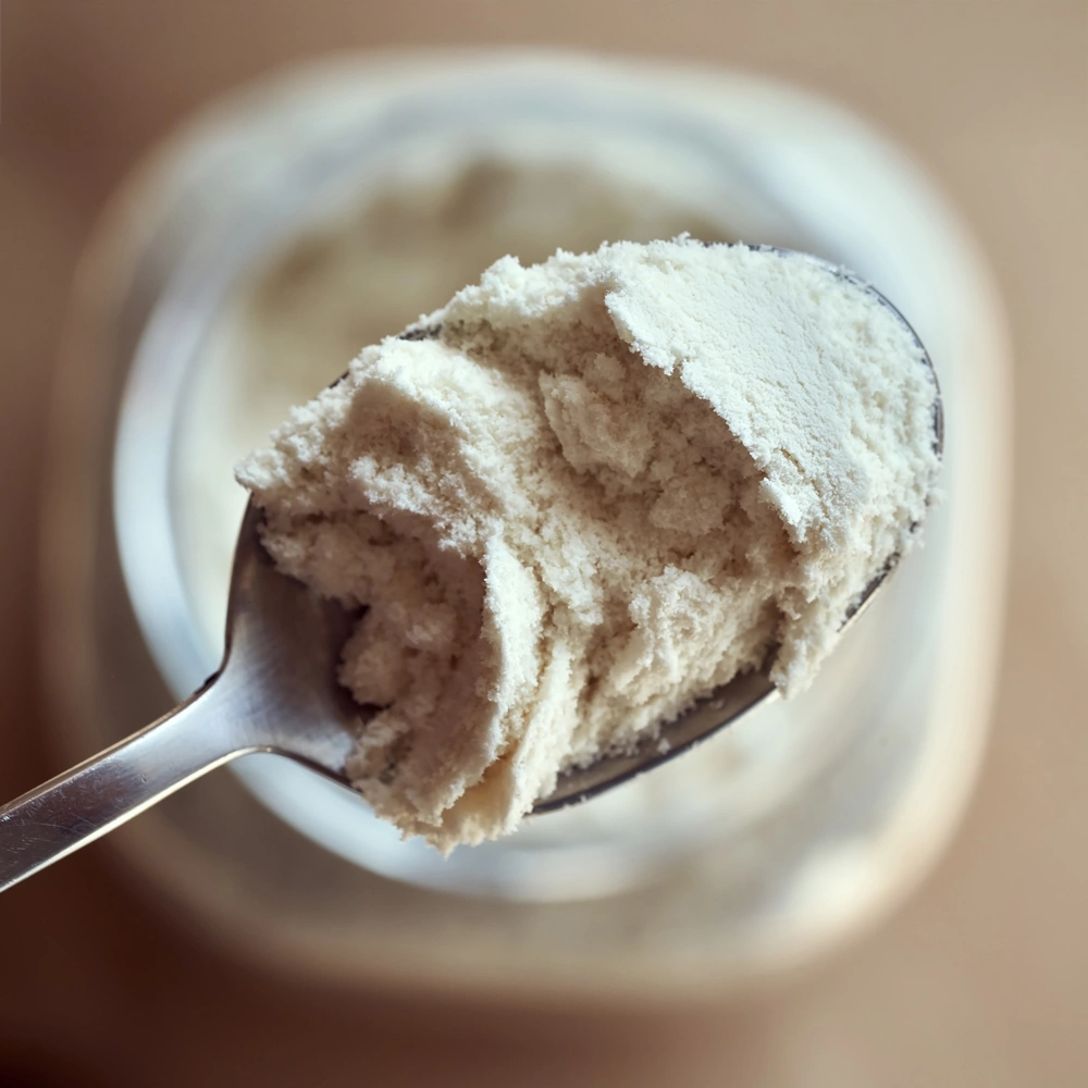 Hands taking a scoop of powder product