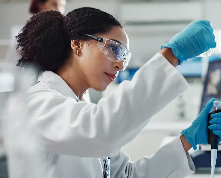 Scientist manipulating lab equipment