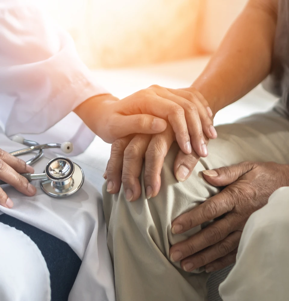 Doctor holding senior patient hands