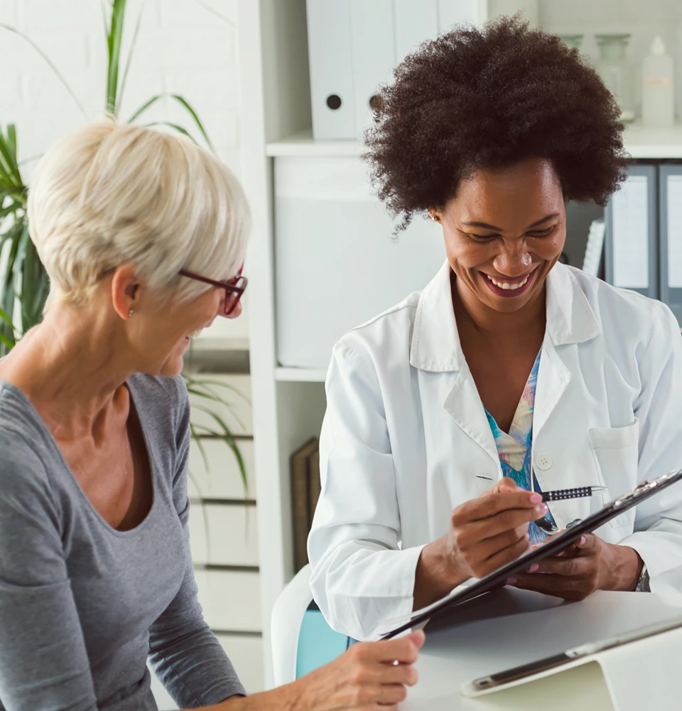 Health professional talking to senior woman