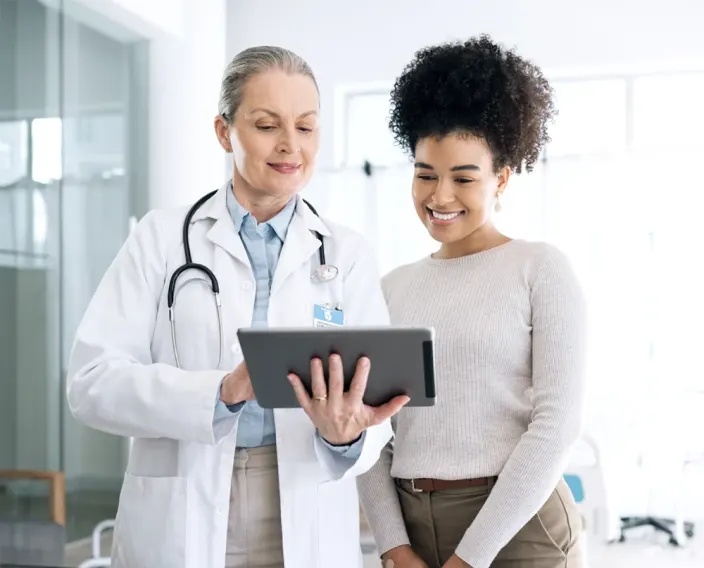 Female doctor and female patient standing