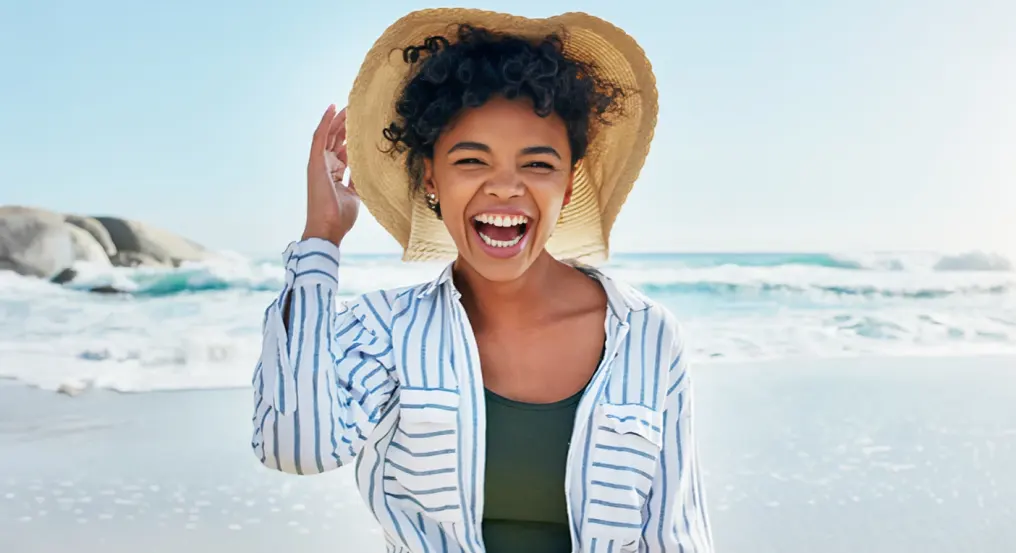 Young woman smiling at the beach