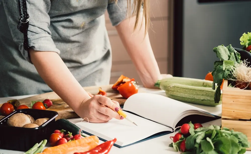 Woman consulting recipe.