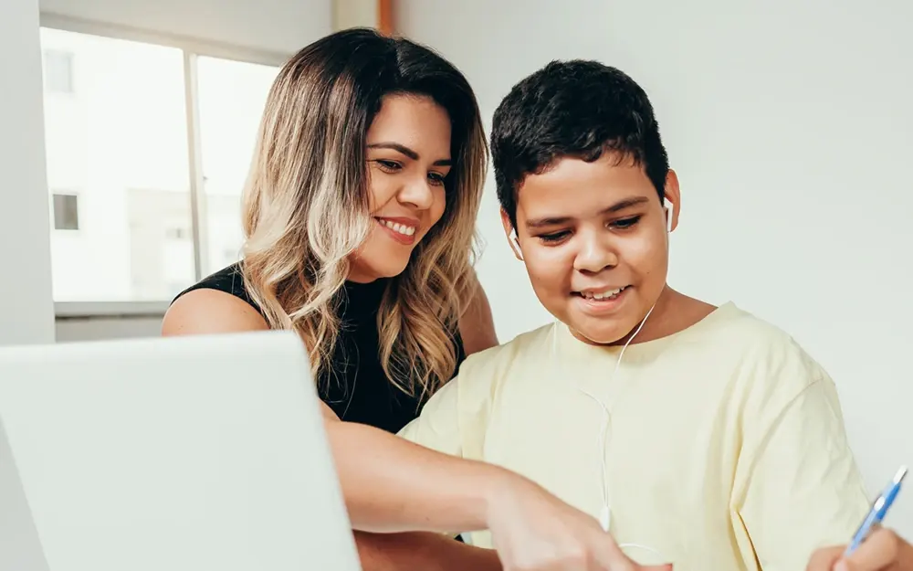 Woman and child using a laptop computer.