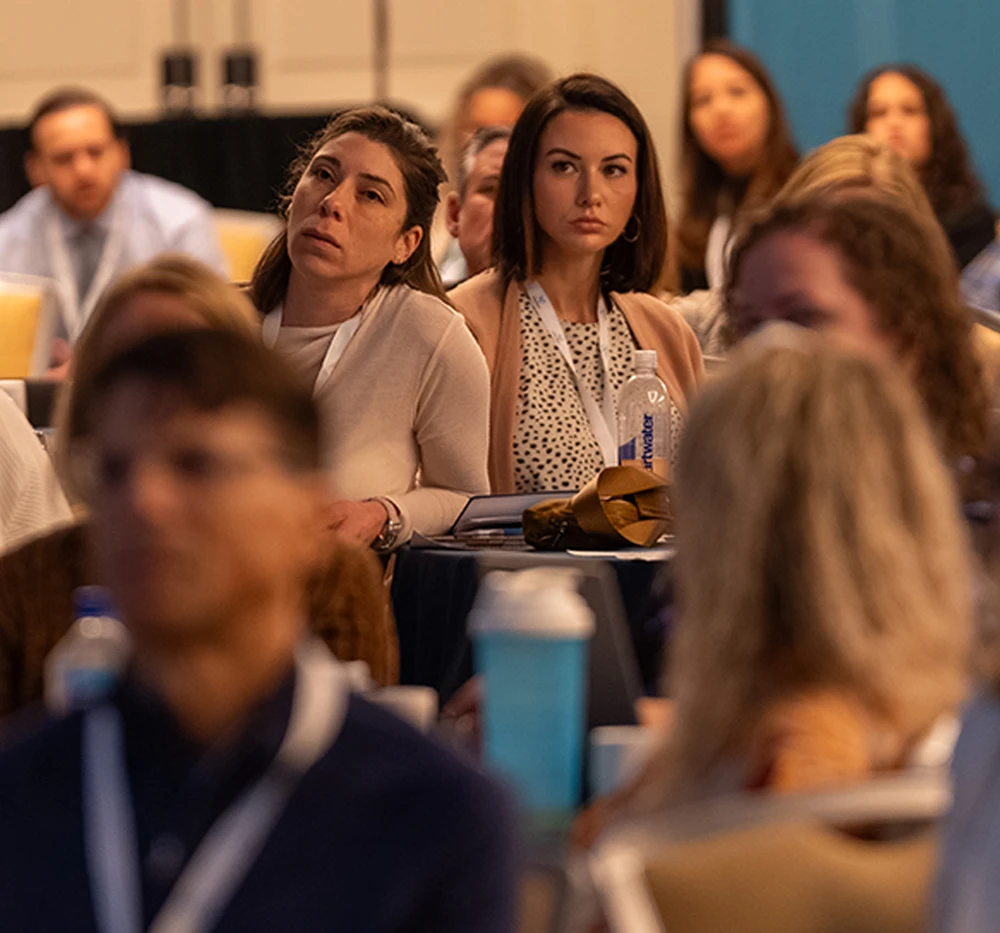 Practitioners listening in the audience at a XYMOGEN Experience presentation