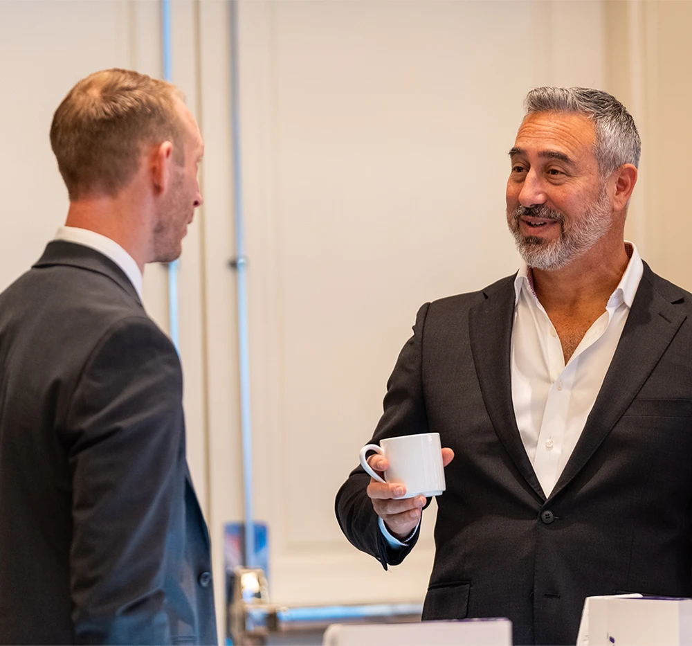 Two colleagues networking at a XYMOGEN Experience event